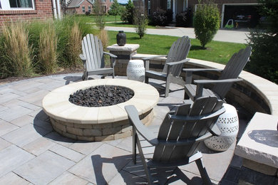 Design ideas for a small traditional backyard patio in Indianapolis with a fire feature, brick pavers and no cover.
