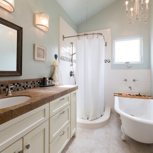 Inspiration for a beach style 3/4 white tile and subway tile beige floor bathroom remodel in San Luis Obispo with shaker cabinets, white cabinets, blue walls, an undermount sink, tile countertops and brown countertops