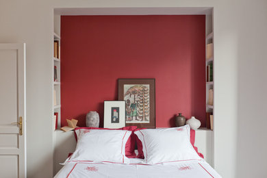 Small tropical guest bedroom in Paris with red walls.