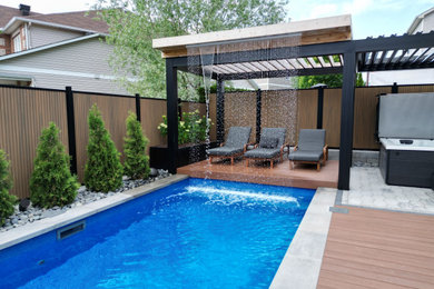 Inspiration for a contemporary backyard rectangular pool landscaping remodel in Ottawa with decking