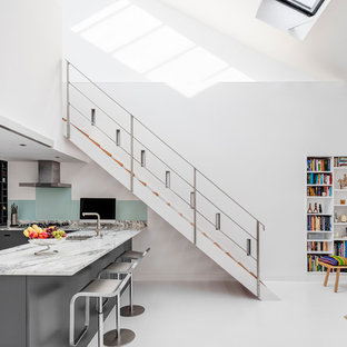 Inspiration for a medium sized contemporary wood straight wire cable railing staircase in London.