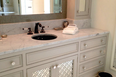 Inspiration for a large transitional master bathroom in Tampa with recessed-panel cabinets, grey cabinets, a freestanding tub, stone tile, limestone floors, marble benchtops, a corner shower, a two-piece toilet, grey walls, an undermount sink, white floor and a hinged shower door.