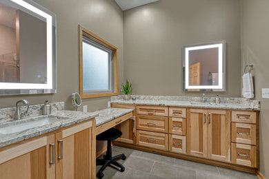 Example of a large transitional master porcelain tile and double-sink bathroom design in Minneapolis with recessed-panel cabinets, an undermount sink, granite countertops and a built-in vanity