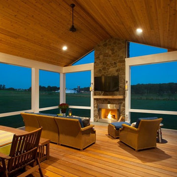Design Builders screened porch with stone fireplace & Ipe deck in Sykesville MD