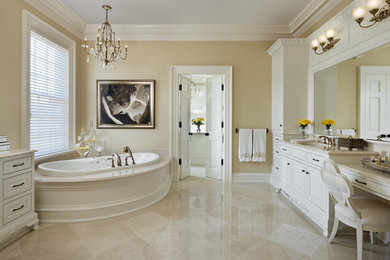 Large elegant master marble floor and beige floor bathroom photo in Other with raised-panel cabinets, white cabinets, a hot tub, beige walls, an undermount sink and beige countertops