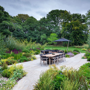 This is an example of a traditional patio in Hampshire with tiled flooring and no cover.