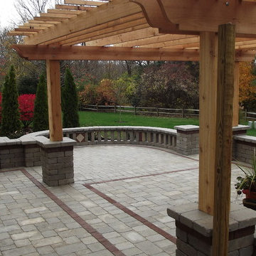 Dark stone with red brick accents and pergola