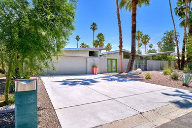 Large 1950s gray one-story house exterior photo in Other with a hip roof