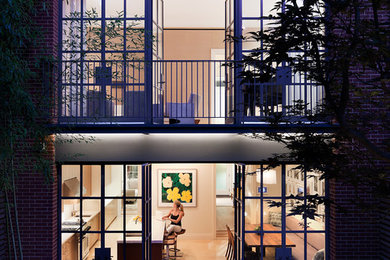 Inspiration for a modern brick townhouse exterior remodel in New York