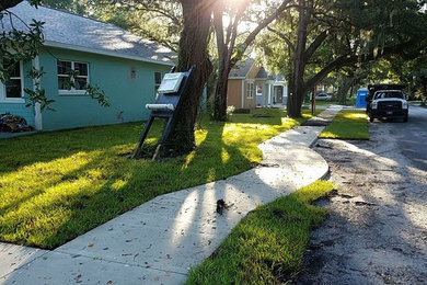 Mid-sized arts and crafts multicolored one-story concrete fiberboard exterior home photo in Tampa with a shingle roof