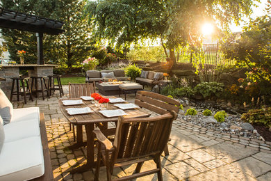 Patio - mid-sized cottage backyard concrete paver patio idea in Philadelphia with a fire pit and a pergola