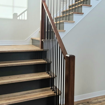Reclaimed Mixed Hardwood Flooring and Stair Treads in a Transitional Staircase