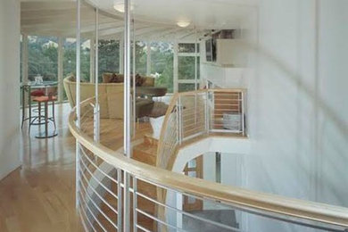 Hallway - large modern light wood floor and brown floor hallway idea in San Francisco with white walls