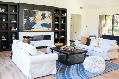 Inspiration for an open concept light wood floor living room remodel in Philadelphia with white walls