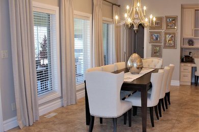 Mid-sized transitional ceramic tile and multicolored floor kitchen/dining room combo photo in Other