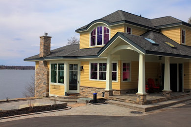 Inspiration for a large timeless yellow two-story wood exterior home remodel in Toronto