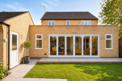 Inspiration for a medium sized contemporary bungalow brick and rear house exterior in Other with a flat roof.