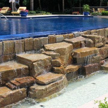 Pool rock waterfall on infinity edge pool