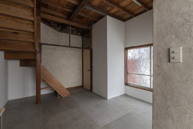 Imagen de comedor de cocina contemporáneo pequeño con paredes blancas, suelo de cemento, suelo gris y vigas vistas