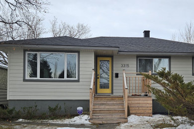 Mid-sized traditional beige one-story concrete fiberboard and clapboard house exterior idea in Calgary