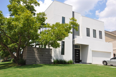 Large modern white three-story stucco exterior home idea in Houston