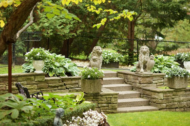 Design ideas for a large traditional partial sun backyard landscaping in Toronto.