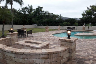 Medium sized modern back patio in Orlando with an outdoor kitchen, concrete paving and a pergola.