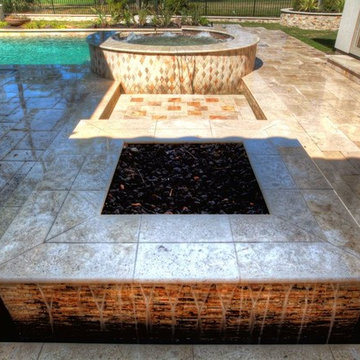 Rectangular pool with walkover water feature, fire pit, and landscape