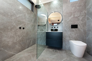 Design ideas for a mid-sized contemporary master bathroom in Other with black cabinets, an open shower, a wall-mount toilet, gray tile, porcelain tile, grey walls, porcelain floors, a vessel sink, marble benchtops, grey floor, an open shower and white benchtops.