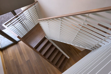 Design ideas for a mid-sized contemporary carpeted staircase in Cork with carpet risers.