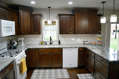 Inspiration for a mid-sized craftsman u-shaped dark wood floor eat-in kitchen remodel in Other with an undermount sink, shaker cabinets, granite countertops, white backsplash, subway tile backsplash, white appliances, a peninsula and dark wood cabinets