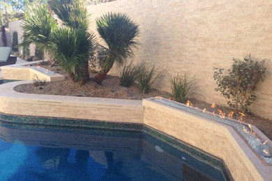 Example of a mid-sized tuscan beige two-story stone exterior home design in Las Vegas