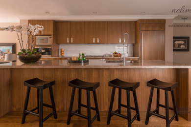 Mid-sized minimalist galley medium tone wood floor eat-in kitchen photo in Toronto with a drop-in sink, flat-panel cabinets, medium tone wood cabinets, granite countertops, white backsplash, porcelain backsplash, paneled appliances and an island