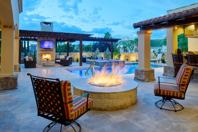 Example of a mid-sized tuscan backyard stone patio design in Other with a fire pit and a pergola