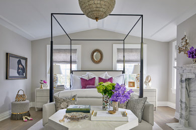 Inspiration for a large transitional master medium tone wood floor and vaulted ceiling bedroom remodel in DC Metro with white walls, a standard fireplace and a stone fireplace