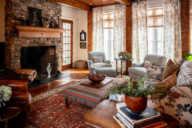 Example of a large eclectic exposed beam living room design in Other