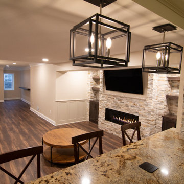 Basement Showing Warm Colors, Straight Lined Cabinets and Stacked Stone