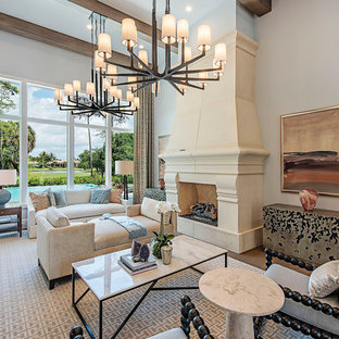 Ejemplo de salón para visitas mediterráneo, sin televisor, con paredes grises, suelo de madera en tonos medios y chimenea tradicional