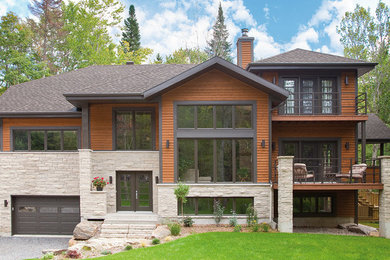 Design ideas for a contemporary brown house exterior in Montreal with wood siding.