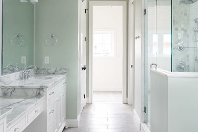 Example of a classic bathroom design in Louisville with green walls and marble countertops