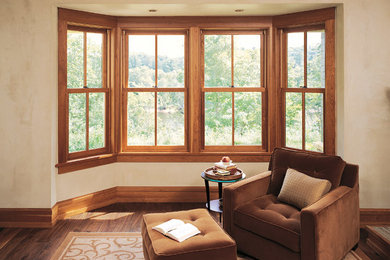 Example of a mid-sized classic open concept dark wood floor and brown floor family room design in Minneapolis with beige walls