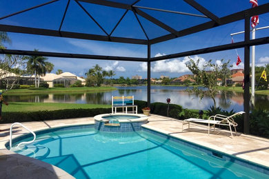Hot tub - mid-sized tropical backyard tile and kidney-shaped hot tub idea in Miami
