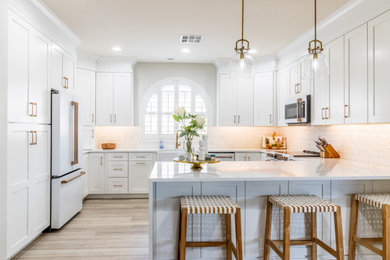 Transitional kitchen photo in Phoenix with shaker cabinets, white cabinets, quartz countertops, white backsplash, white appliances and white countertops