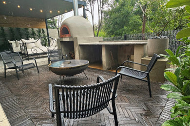 Inspiration for a small mediterranean front yard tile patio remodel in Other with a roof extension
