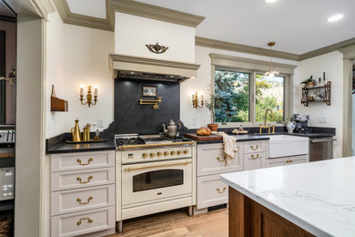 Enclosed kitchen - large french country galley light wood floor and beige floor enclosed kitchen idea in Other with a farmhouse sink, recessed-panel cabinets, beige cabinets, quartz countertops, black backsplash, quartz backsplash, white appliances, an island and multicolored countertops