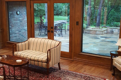 Living room - mid-sized traditional enclosed light wood floor living room idea in Dallas with no fireplace and no tv