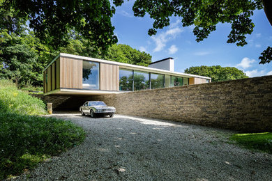 This is an example of a contemporary one-storey exterior in Hampshire with wood siding.