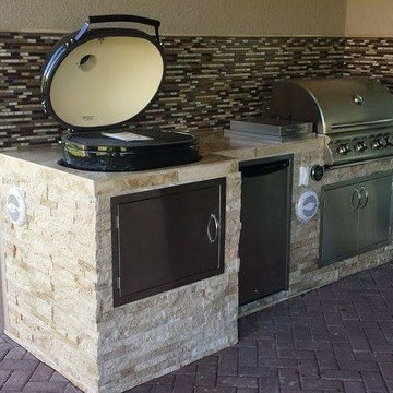 Outdoor Kitchen with Stacked Stone Exterior and Primo Oval