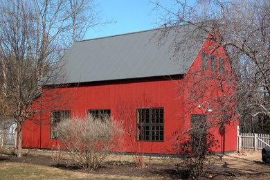 Inspiration for a mid-sized farmhouse red two-story wood gable roof remodel in Burlington