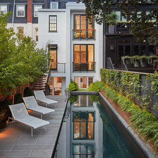 ワシントンD.C.の大きい長方形トランジショナルスタイルのおしゃれなプール (天然石敷き) の写真